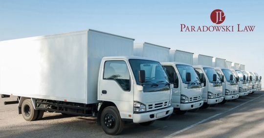 a line of commercial trucks parked